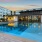 a pool in a courtyard with buildings in the background