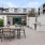a patio with tables and chairs outside