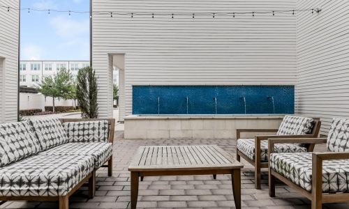 a patio with chairs and a table