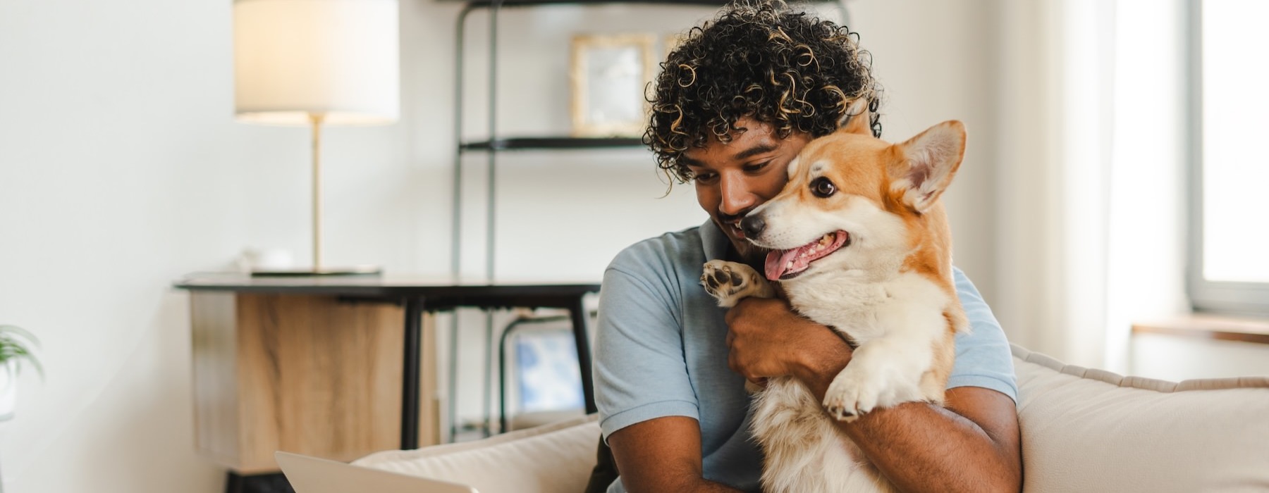 a person holding a dog on a couch