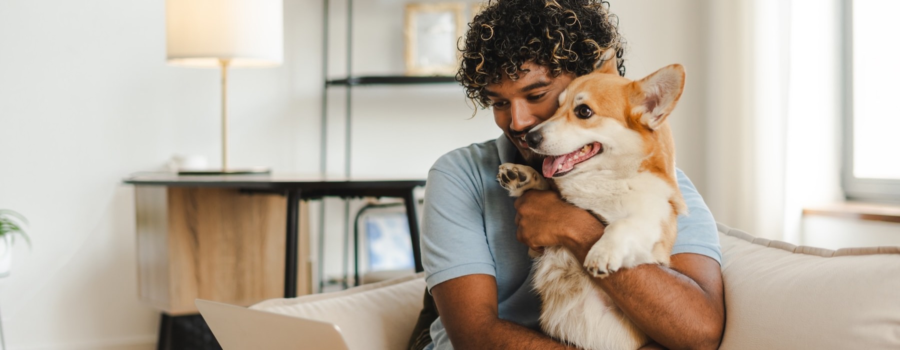 a person holding a dog on a couch